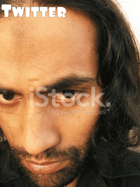 a close up of a man 's face with the word twitter written above him