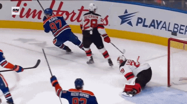a hockey game is being played in front of a playalber sign