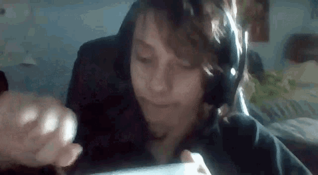 a close up of a person wearing headphones while playing a video game .