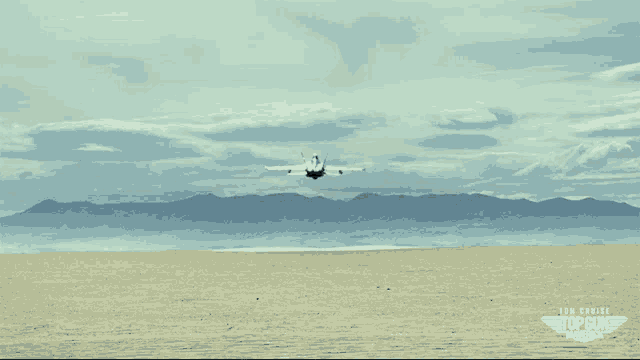 a movie poster for top gun maverick shows a plane flying over the desert