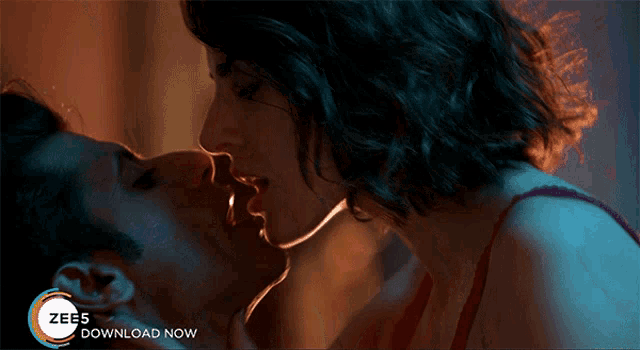 a man and woman kissing with the words zee5 download now