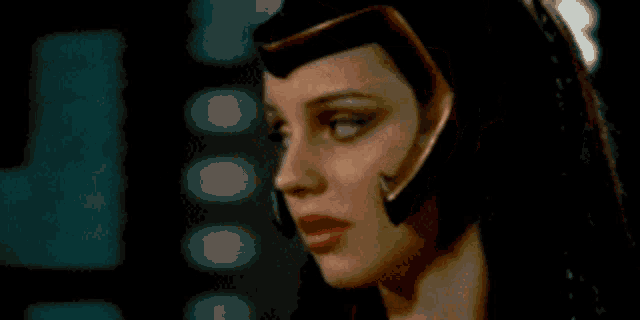 a close up of a woman 's face wearing a helmet and headphones .