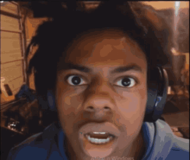 a young man wearing headphones is making a funny face