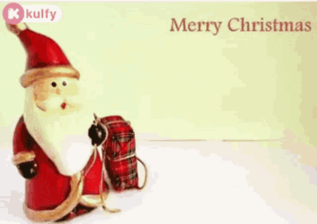 a christmas card with a santa claus figurine holding a gift box .
