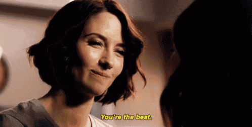 a woman is smiling at another woman and saying `` you 're the best . ''