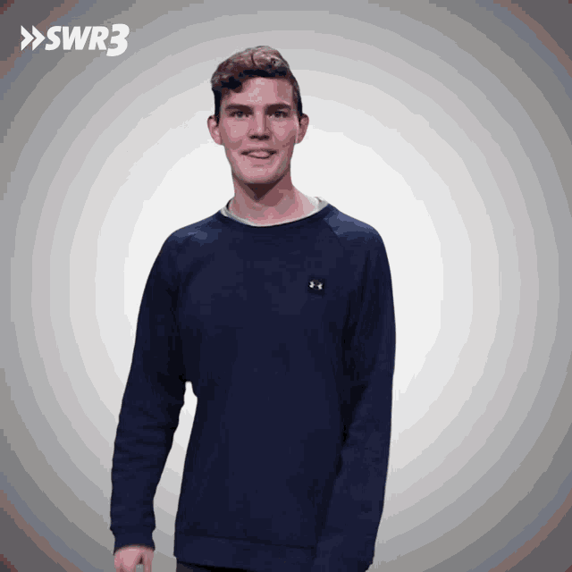 a young man wearing a blue under armour sweatshirt