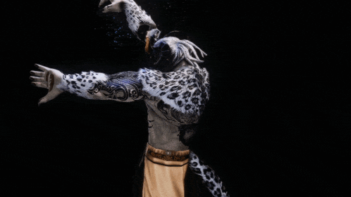 a person with a leopard print on their body is holding a ball