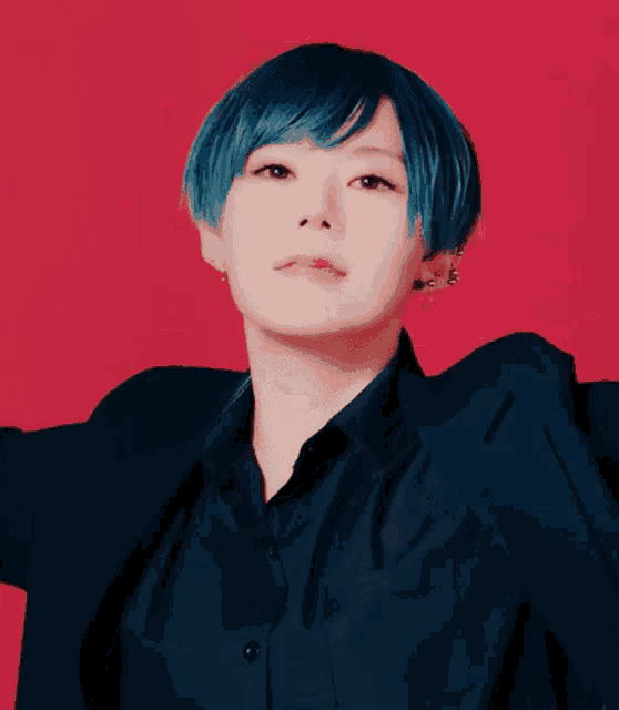 a woman with blue hair is wearing a black shirt and jacket