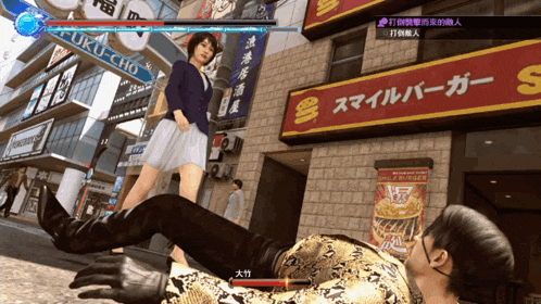a man is laying on the ground in front of a fuku-cho restaurant