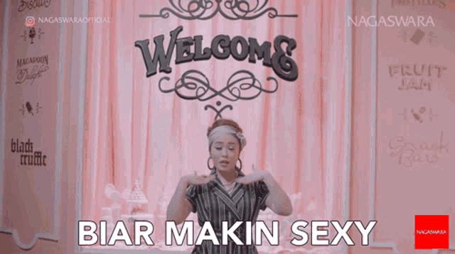 a woman is standing in front of a sign that says welcome biar makin sexy