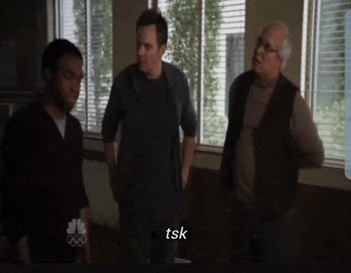 three men are standing in front of a window and one of them says " tsk "