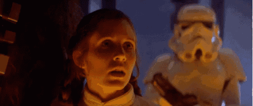 a woman is standing in front of a stormtrooper and says i love you .