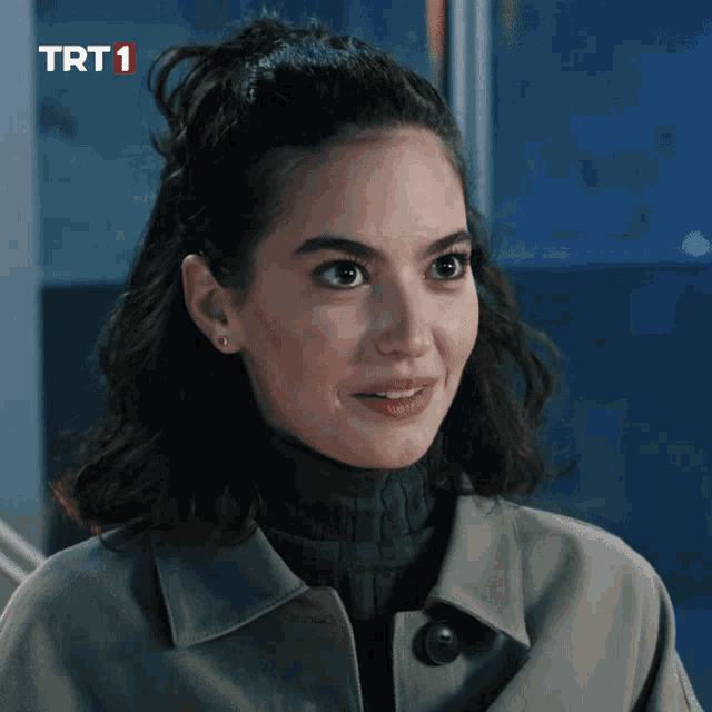 a close up of a woman 's face with the trt1 logo in the corner