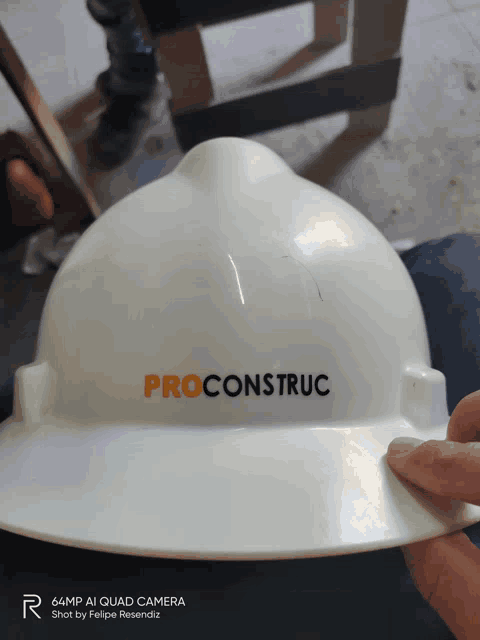 a person is holding a hard hat that says proconstruct
