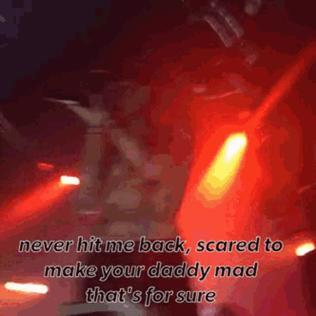 a man is singing into a microphone on a stage with a caption that says never hit me back scared to make your daddy mad