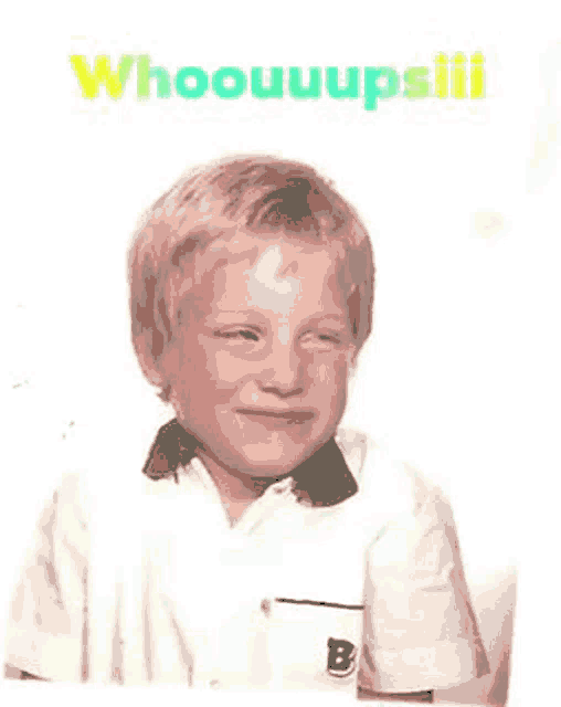 a young boy wearing a white shirt with a green collar and the words whooouuupsiii on the bottom