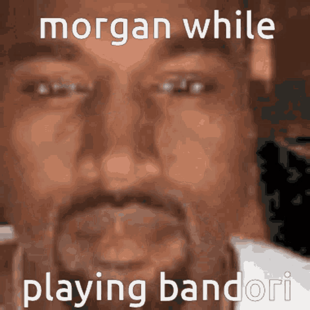 a close up of a man 's face with the words " morgan while playing bandori " on it