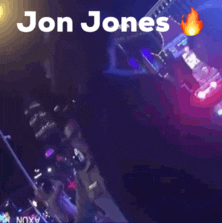 a blurry picture of jon jones with a flaming object in the background