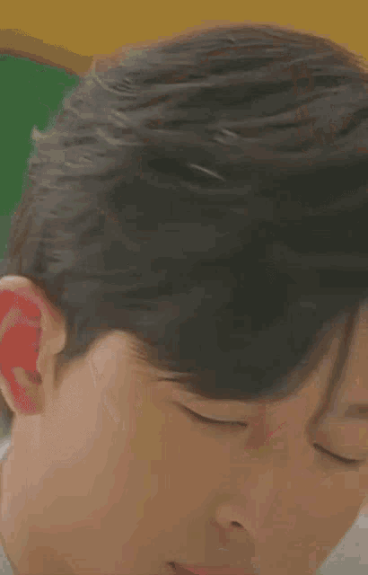 a close up of a man 's face with his eyes closed .