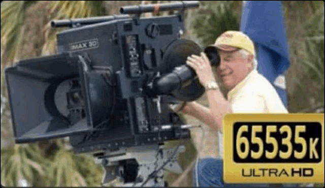 a man is taking a picture with a camera that says 65535k ultra hd