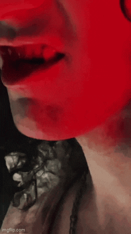 a close up of a woman 's face with red paint on it .