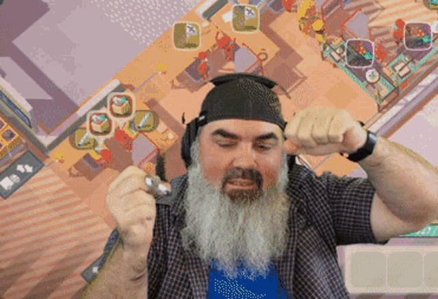 a man with a beard is wearing headphones in front of a video game