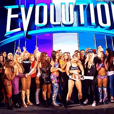 a group of women are standing in front of a sign that says evolution .