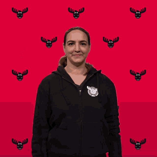 a woman wearing a black hoodie with swr3 crew written on the back