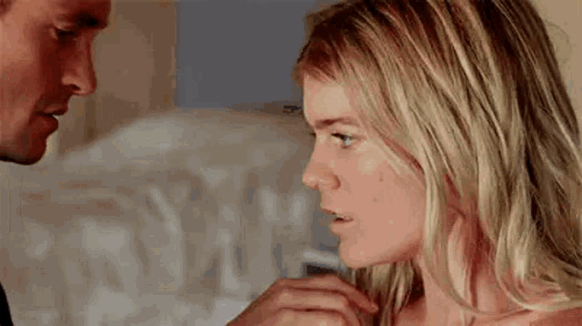 a man and a woman are looking at each other .