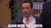 a man in a suit and tie is talking to another man in a room .