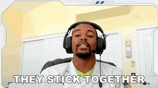 a man wearing headphones with the words they stick together below him