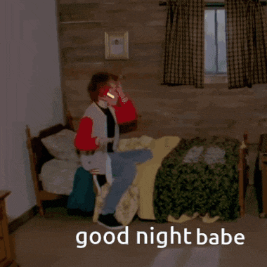 a person laying in a bed with the words good night babe written on the floor
