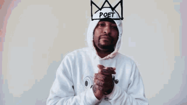 a man wearing a white hoodie with a drawing of a crown on his head that says poet