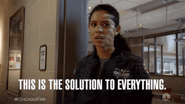 a woman standing in a hallway with the words this is the solution to everything