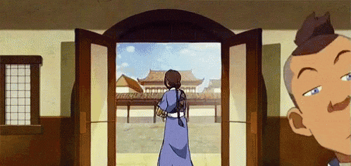a woman in a blue dress is standing in front of a door .