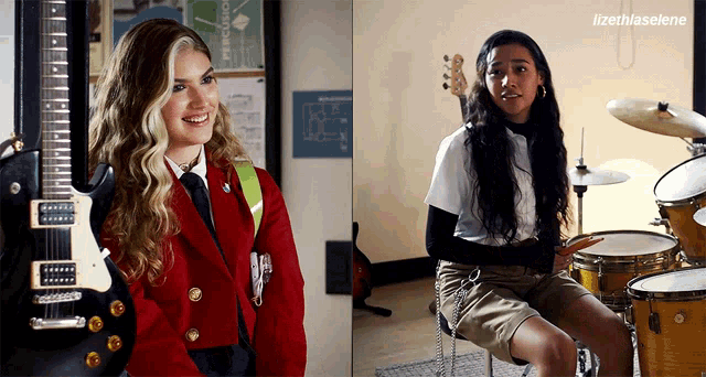 a girl in a red jacket holds a guitar next to a girl playing drums