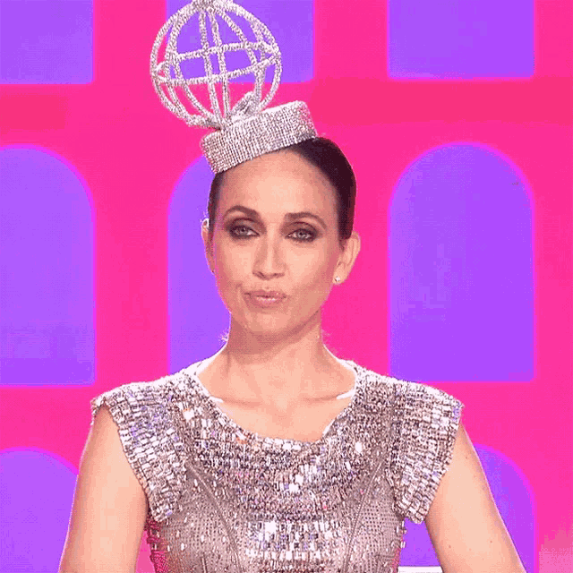 a woman wearing a crown with a globe on top of her head