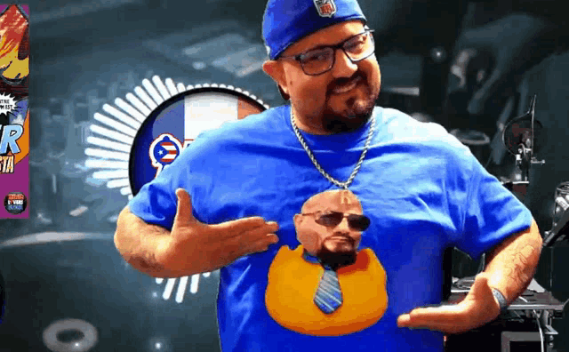 a man wearing a blue shirt with a picture of a man and a duck on it
