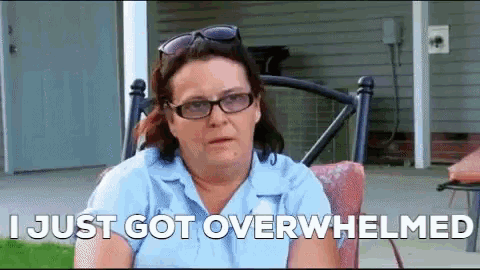 a woman wearing glasses is sitting in a chair with the words i just got overwhelmed written below her
