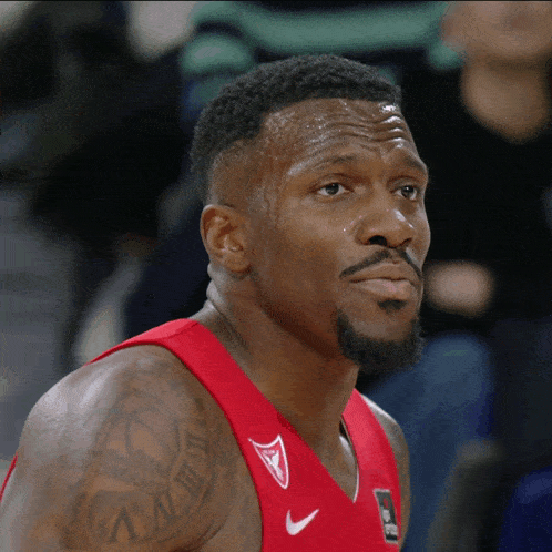 a basketball player with a tattoo on his arm that says " i dream "