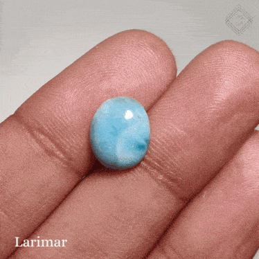 a person is holding a blue stone in their hand with the word larimar on the bottom