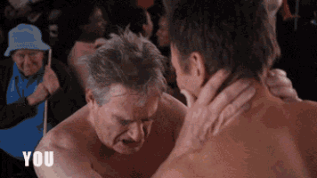 two men are wrestling and one of them is saying you