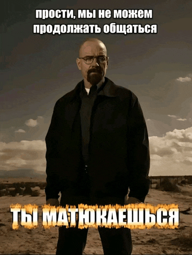 a man with glasses and a beard is standing in a desert with a foreign language caption behind him