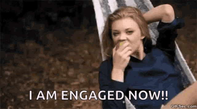a woman is sitting in a hammock eating an apple and says `` i am engaged now '' .
