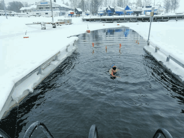 a person is swimming in a body of water with a sign that says ' swimming ' on it