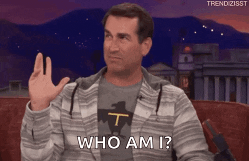a man is sitting on a couch with his hand up and asking who am i