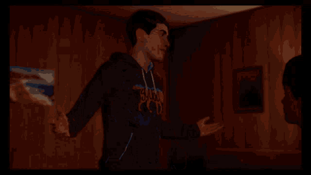 a man in a plaid shirt has the word tnt on his sweatshirt