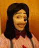 a close up of a person wearing a mickey mouse mask and bow tie .