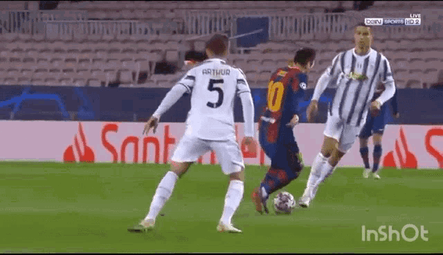 a soccer player in a white jersey with the number 5 on it is kicking a soccer ball .