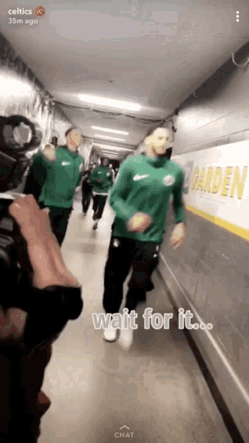 a snapchat of celtics players walking down a hallway with the caption wait for it